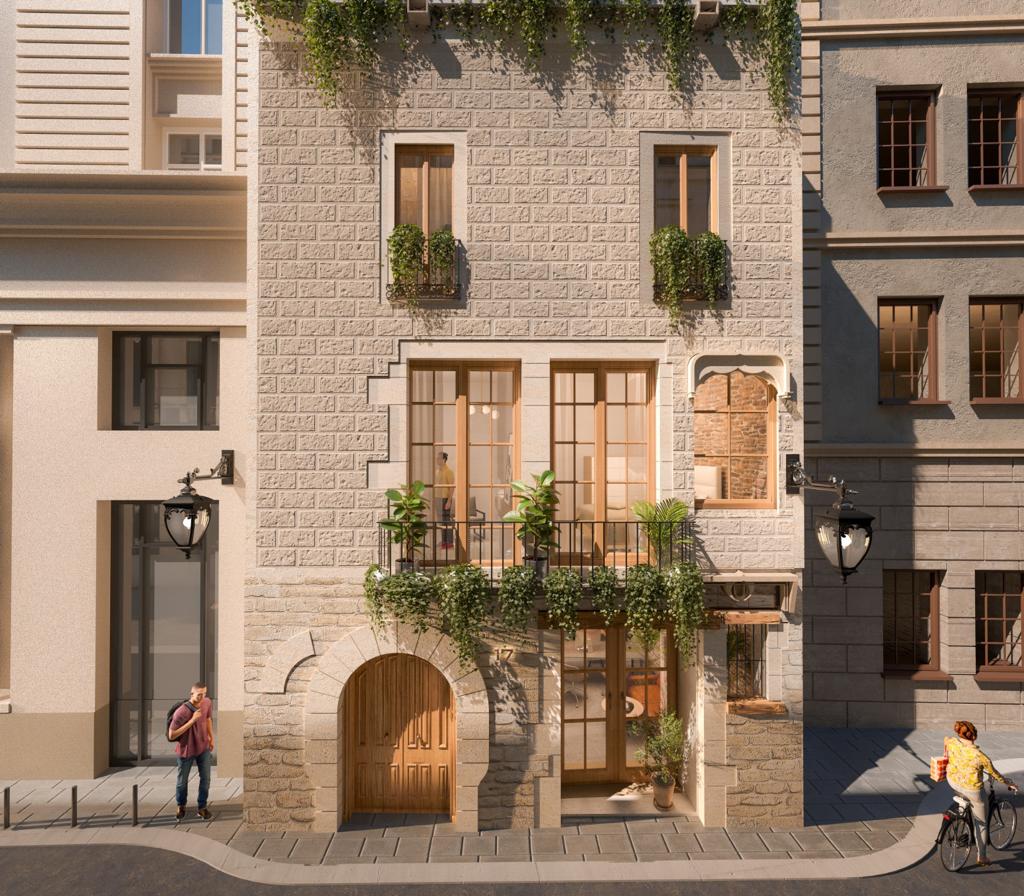 Façade of restored Avinyó 17 building with traditional stone and balconies